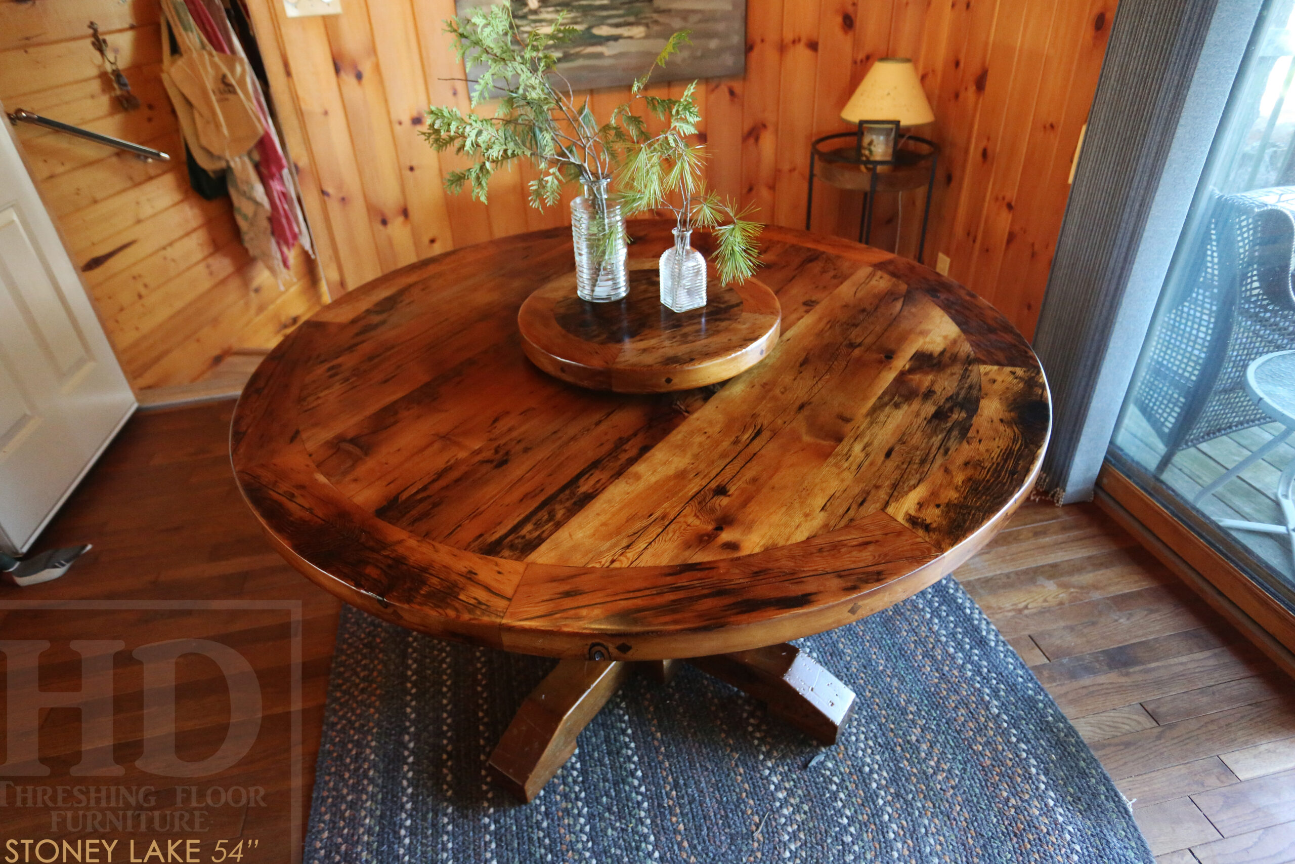 54â€ Reclaimed Ontario Barnwood Round Table we made for a Stoney Lake, Ontario cottage - Old Growth Hemlock Threshing Floor Construction â€“ Hand-Hewn Beam Pedestal Base - Original edges & distressing maintained â€“ Circular Bread Edge Boards â€“ Premium epoxy + satin polyurethane finish â€“ 18â€ Round Lazy Susan - www.table.ca